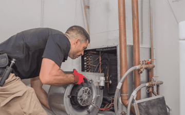 Maintenance worker installs new part 