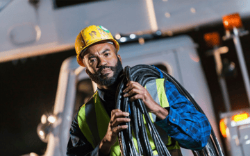 Maintenance worker carries cable to his next job