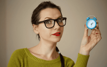 Woman holding an alarm clock 