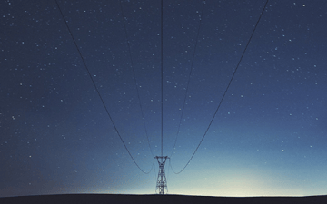 Power lines stretching through the night sky