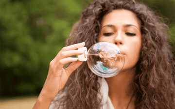 Woman blows a bubble 