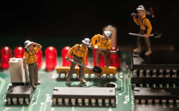 Mining workers on top of a circuit board 