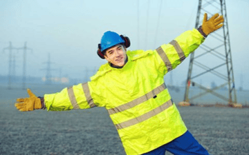 Maintenance worker stands with his hands extended 