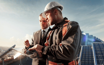 Two men look at a maintenance schedule 