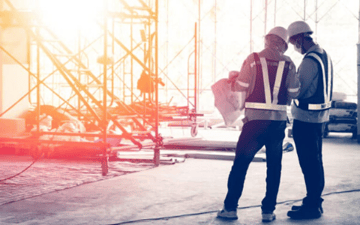 Maintenance worker looks over plans