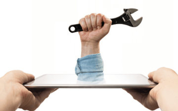 Hand holding a wrench extended through an iPad