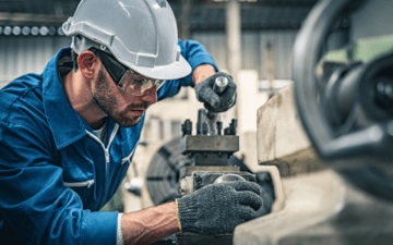 Maintenance worker makes adjustments to equipment 