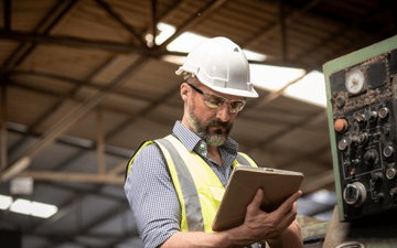 Maintenance planner looks over predictive maintenance report 